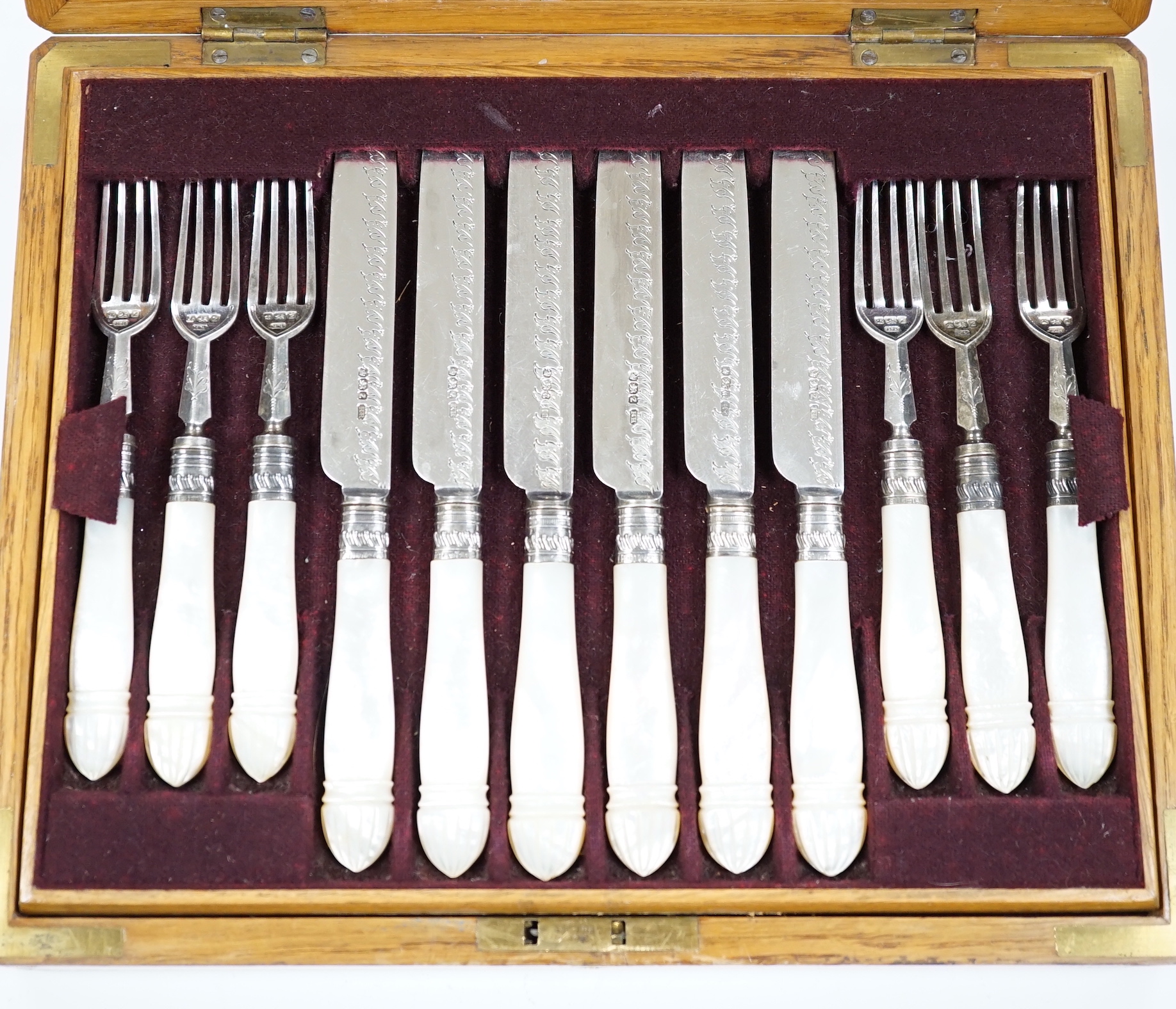 A cased set of twelve pairs of late Victorian mother of pearl handled silver dessert eaters, by Henry Harrison, Sheffield, 1892/3, knife 20cm.